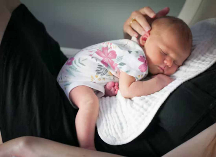 Women holding sleeping baby