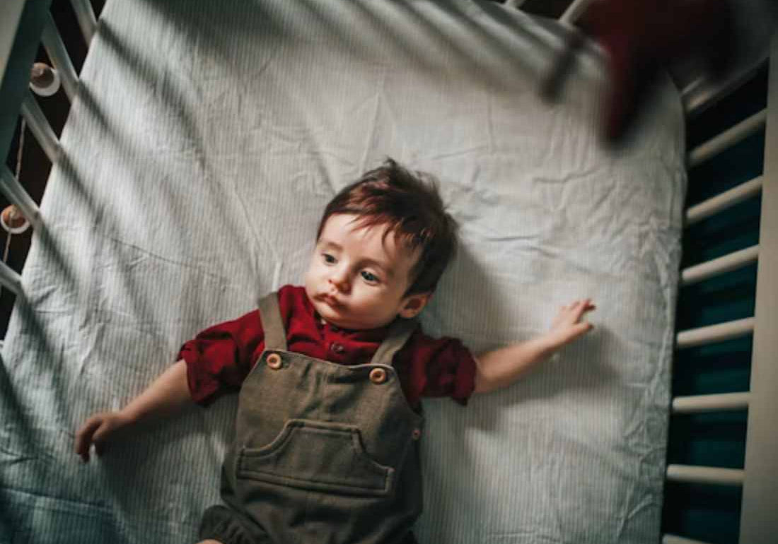 Toddler in a cot