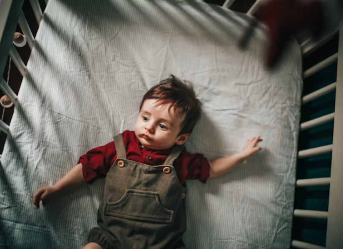 Toddler in a cot