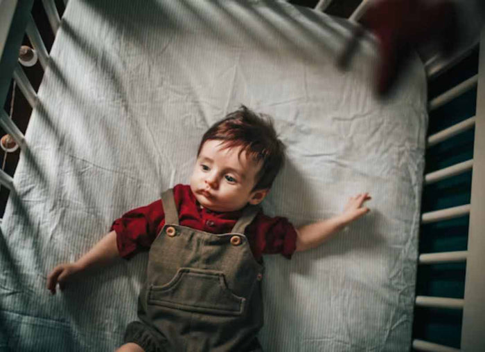 Toddler in a cot