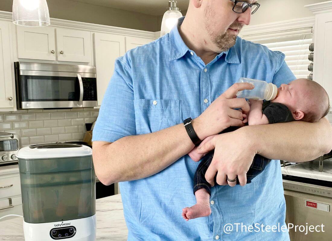 Man feeding baby bottle