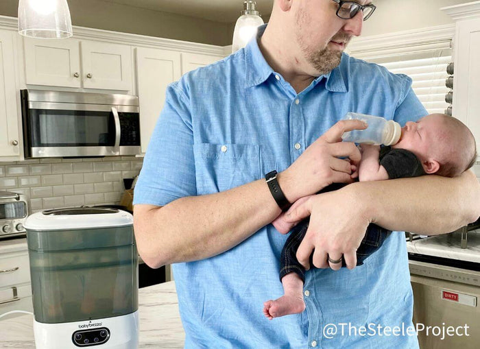 Man feeding baby bottle