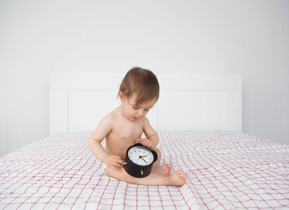 Baby holding a clock