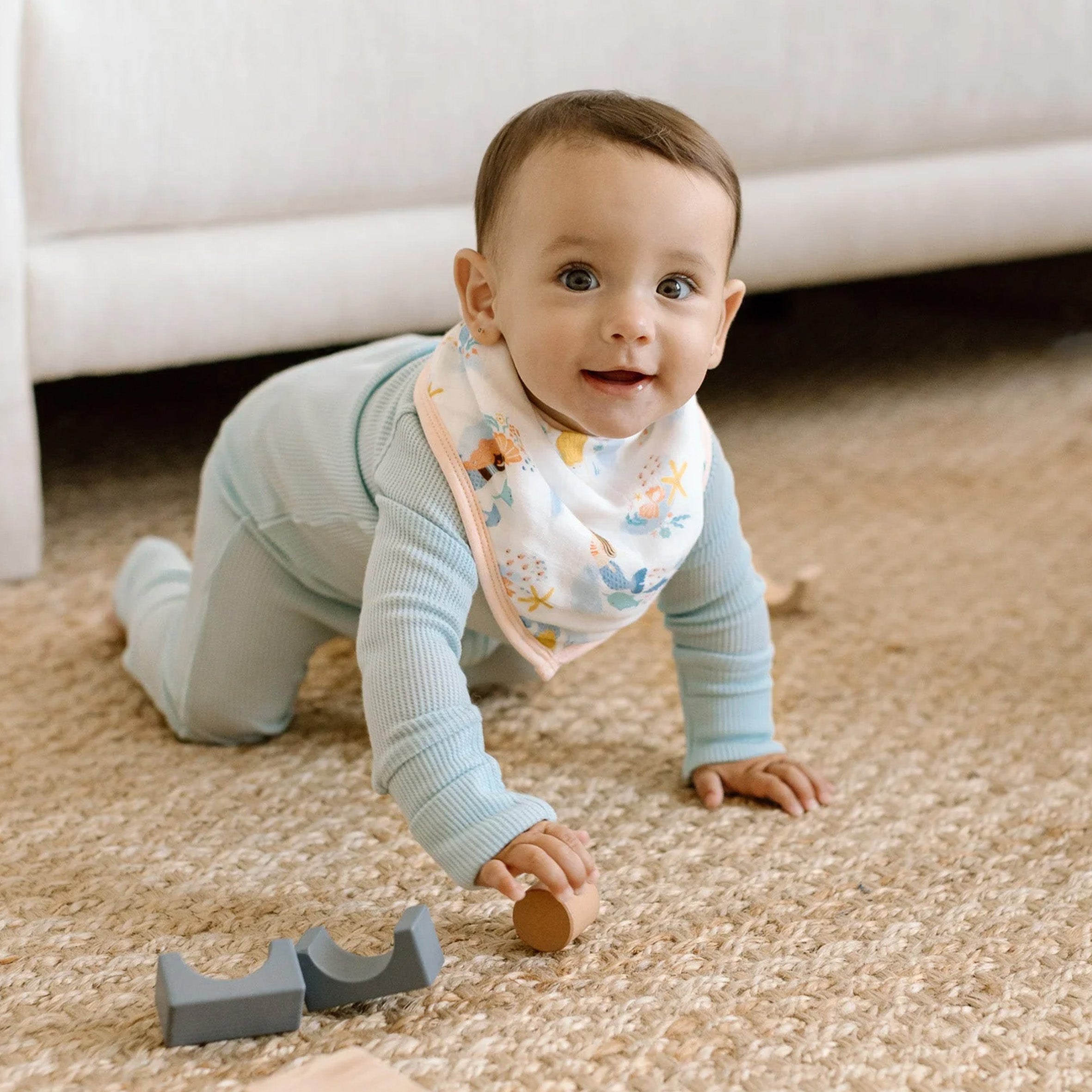 Baby crawling on the floor wearing a Mermaids Bandana Bib