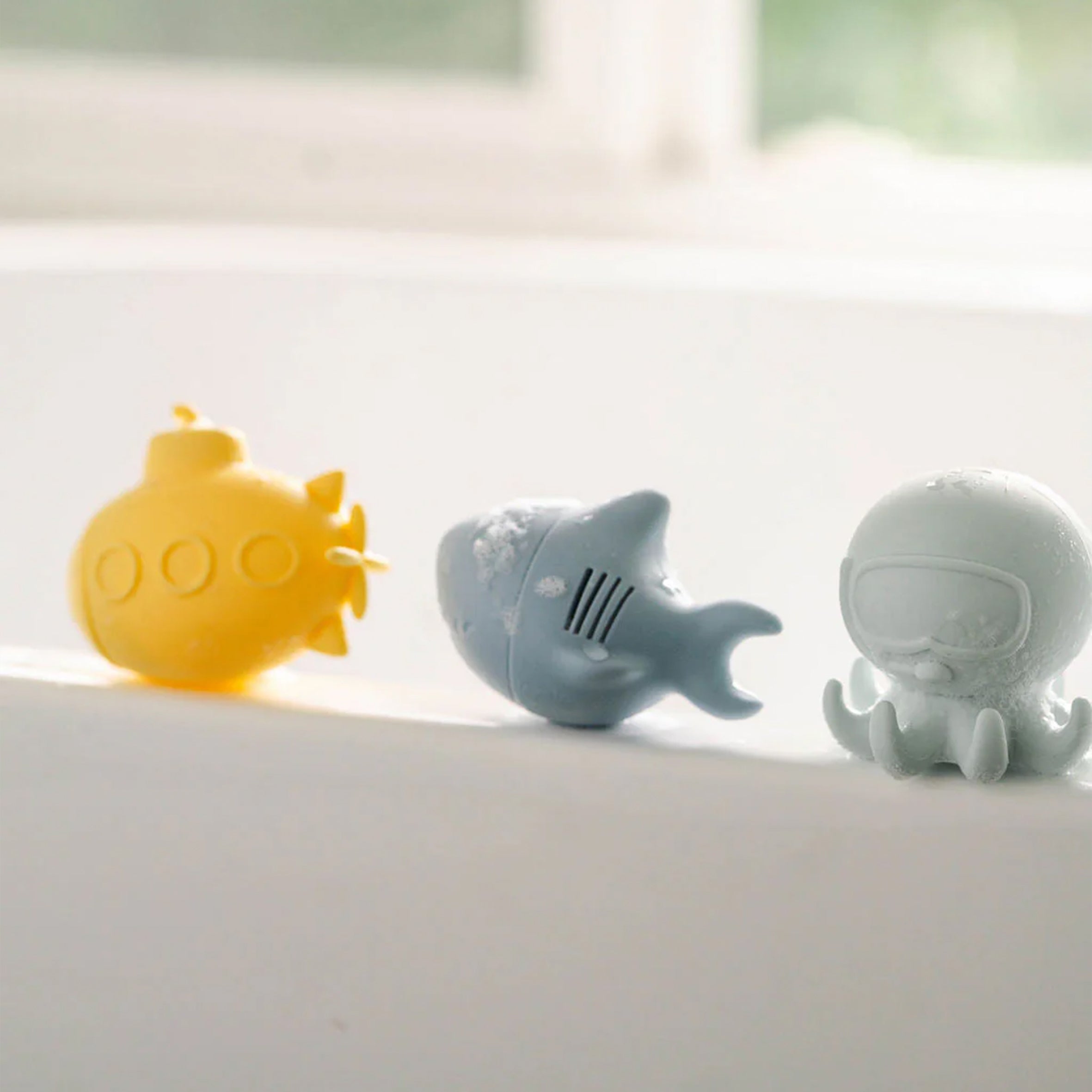 Ocean Wonder Bath Toy Set on the edge of a bath