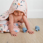 Baby crawling on the floor with a Unicorn Ballet Muslin Swaddle