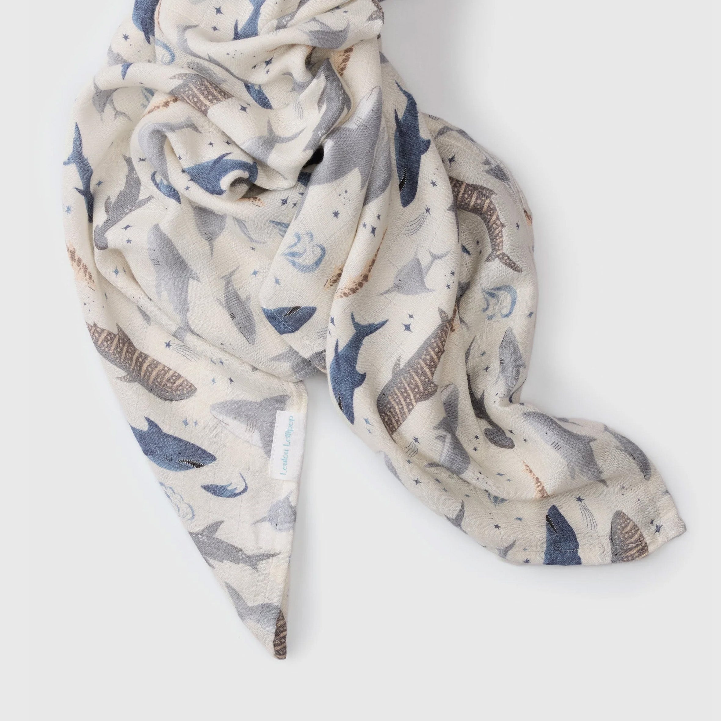 Smiley Sharks Muslin Swaddle on a white background
