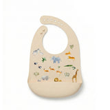 The Safari Jungle, silicone baby bib with a  safari animal print, including an elephant, giraffe, zebra, and lion.