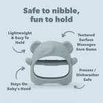 Grey elephant-shaped teething ring with text highlighting its features on a light blue background. Lightweight and easy to hold. Textured surface massages sore gums. Freezer and dishwasher safe. Textured on both sides.