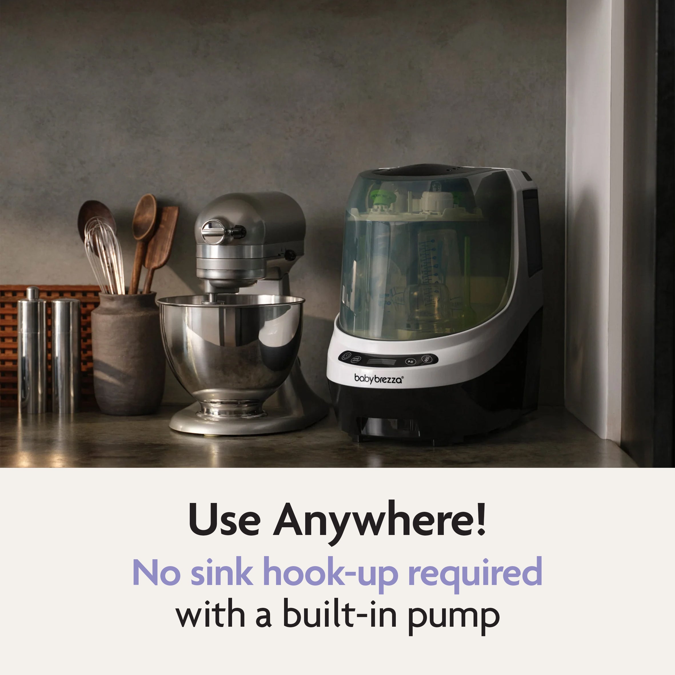 The Baby Brezza Bottle Washer Pro® - All Black sits beside a stand mixer and utensils. Text below reads: Use Anywhere! No sink hook-up needed thanks to the built-in pump on this automatic bottle cleaner by Baby Brezza.
