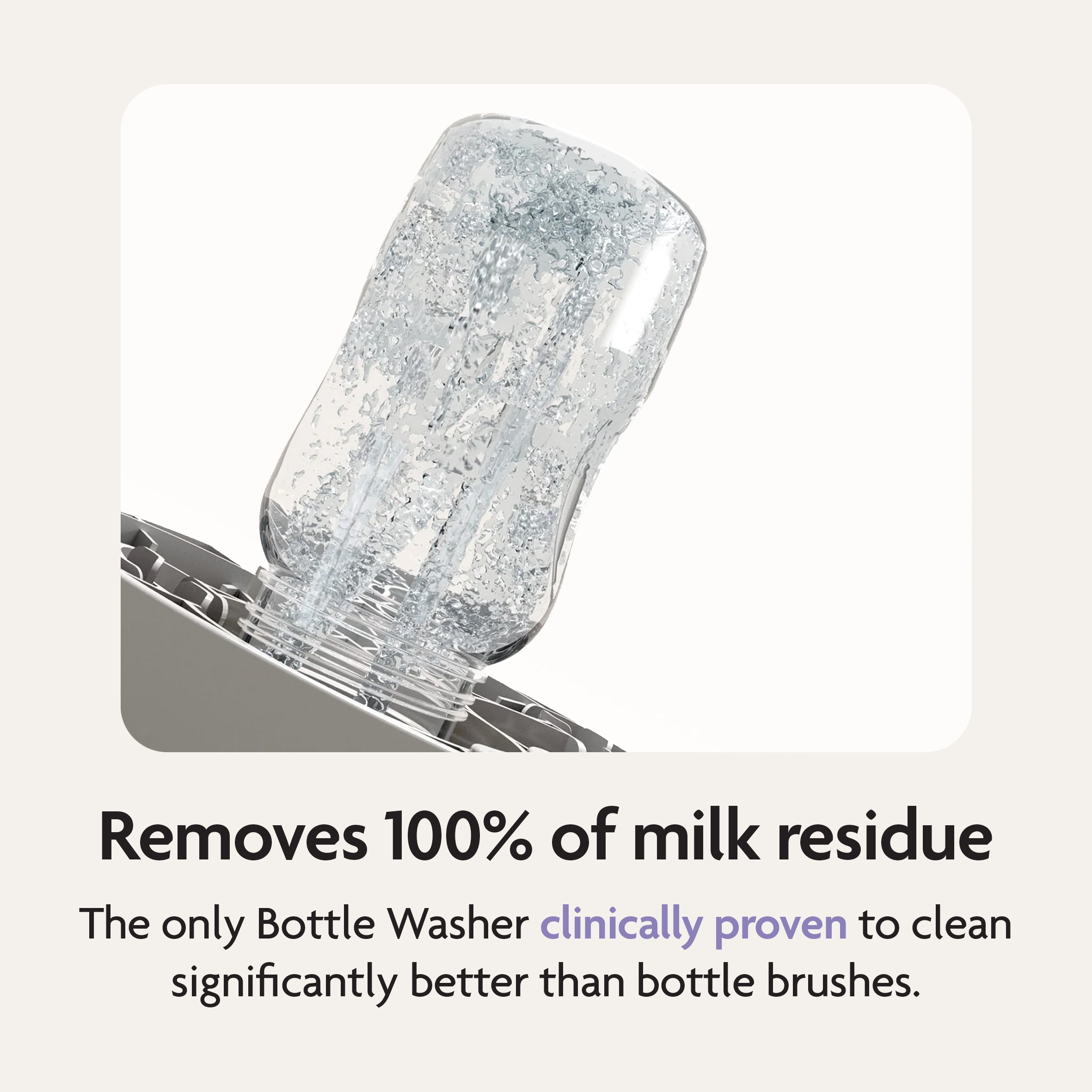 The Baby Brezza Bottle Washer Pro® - All Black cleans a clear baby bottle upside down with water jets. Text: “Removes 100% of milk residue. The only Bottle Washer clinically proven to clean better than bottle brushes.”.