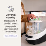 A person loads baby bottles and pump parts into a white PRE-LOVED: Baby Brezza Bottle Washer Pro® - Classic White, next to text highlighting its universal capacity for up to 4 bottles and accessories.