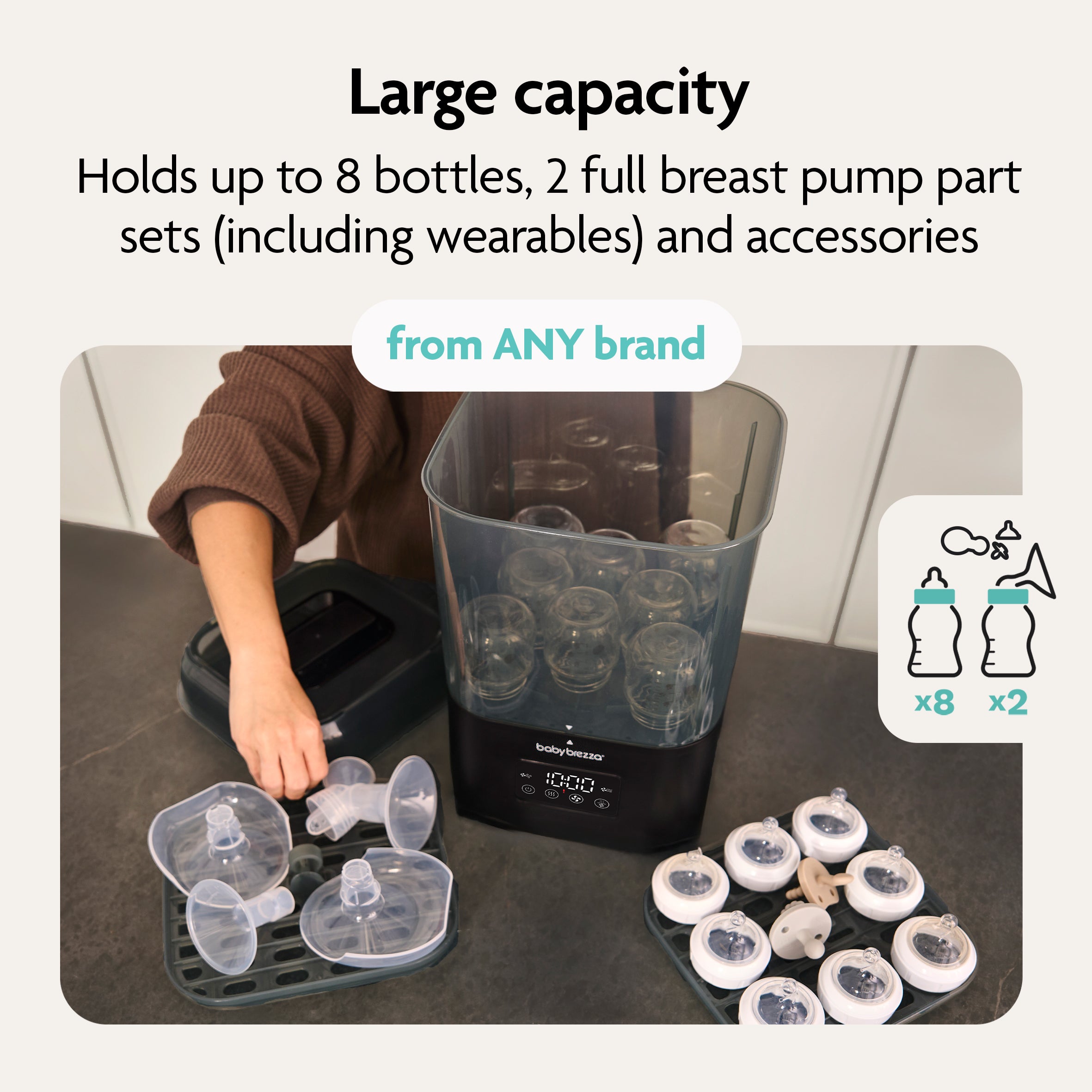 A person loads bottles and breast pump parts into the Baby Brezza SuperQuick Steriliser Dryer. Text: "Largest capacity—holds 8 bottles, 2 full pump part sets (even wearables), and accessories from any brand.