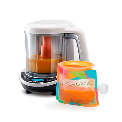 The Baby Brezza Food Maker Deluxe and a colorful reusable pouch labeled “Baby Brezza,” both filled with homemade baby food, are displayed together. Includes FREE food pouches.