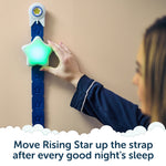 A child in pajamas moves the glowing Rising Star - The rewarding sleep clock by Rockit up a blue strap on the wall, with text: Move Rising Star up the strap after every good night’s sleep—an engaging kids’ sleep trainer by Rockit that helps little ones build healthy routines.