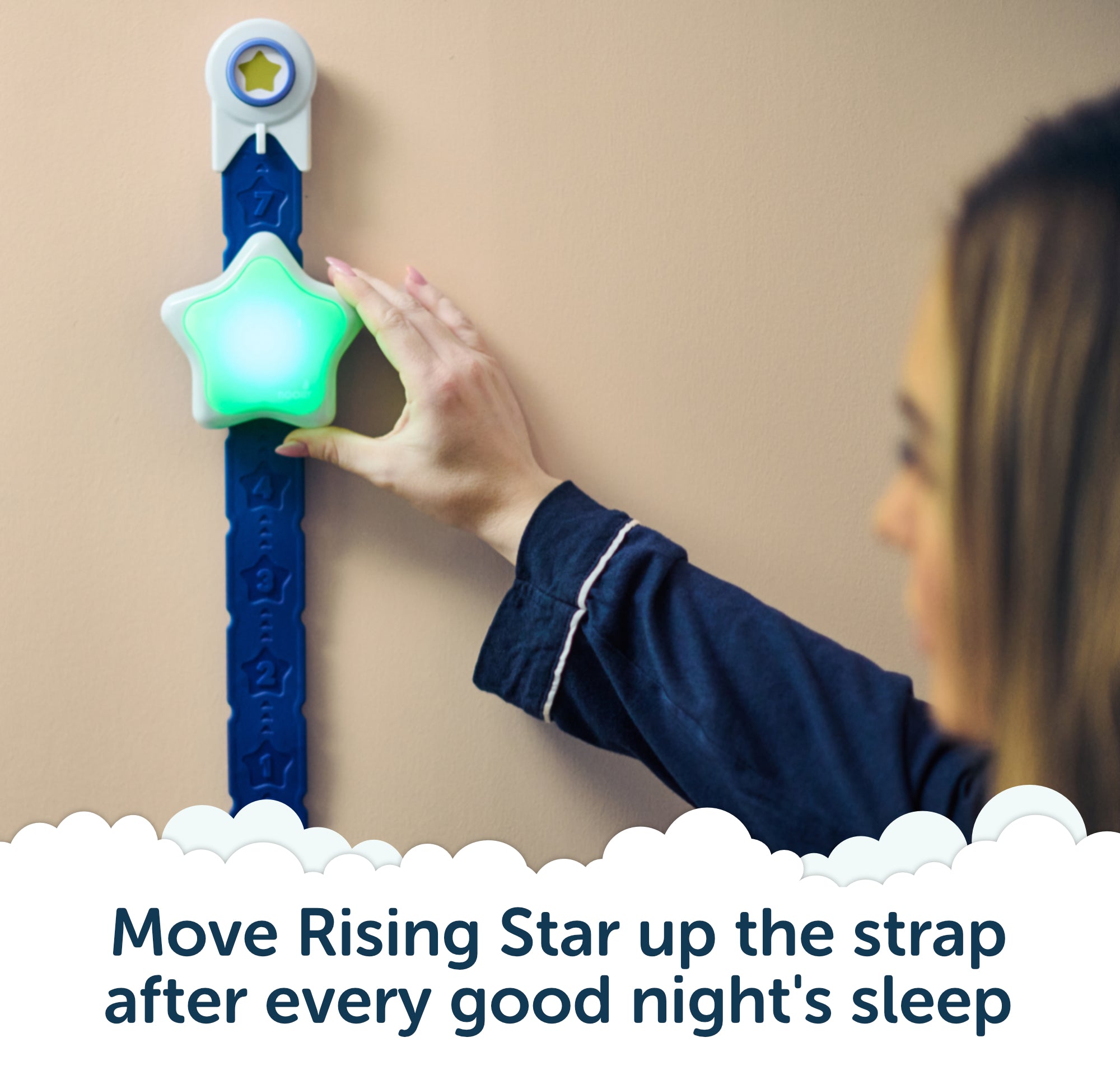 A child in pajamas moves the glowing Rising Star - The rewarding sleep clock by Rockit up a blue strap on the wall, with text: Move Rising Star up the strap after every good night’s sleep—an engaging kids’ sleep trainer by Rockit that helps little ones build healthy routines.
