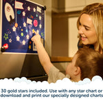 A woman and child smile and point at a space-themed star chart on a fridge. Text below says, 30 gold stars included. Use with any star chart or with the Rising Star – The rewarding sleep clock by Rockit, or download and print our specially designed charts.